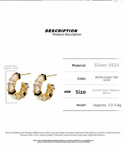 Detail view of gold S925 silver earrings with black and white enamel and zircon stones