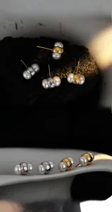 Detail of S925 silver textured earrings with unique double freshwater pearl sandwich design