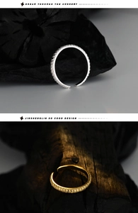 Detail view of retro textured open rings in silver and gold with intricate floral patterns