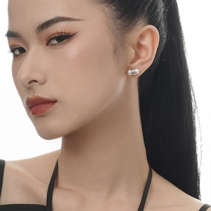 Elegance freshwater pearl earrings in S925 silver worn by a model on white background