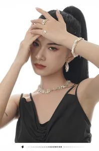 Detail of S925 sterling silver leaf earrings and necklace set on a fashion model