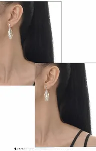 Macro shot of silver S925 sterling silver leaf earrings with swaying fringe detail
