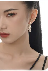 Macro view of S925 sterling silver leaf tassel earrings with multi-layered dangles