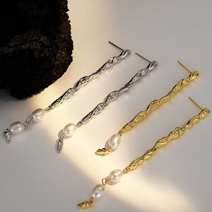 Textured silver and gold asymmetrical lava-style earrings with baroque pearls