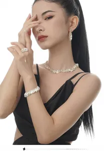 Detailed view of S925 silver leaf jewelry set with necklace, bracelet, and earrings on model