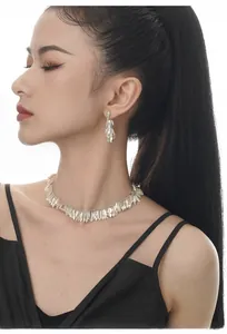 Model wearing S925 sterling silver tassel leaf necklace and dangling earrings set