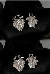 Macro shot of tiered silver leaf tassel earrings crafted from high-quality S925 sterling silver