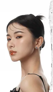 Close-up of a model wearing a sterling silver earring with a sparkling round blue zircon
