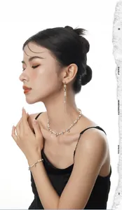 Close-up of S925 sterling silver tassel earrings with baroque pearls on model side view