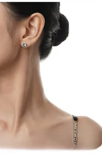 Close-up of elegant S925 sterling silver stud earrings with round cubic zirconia on model