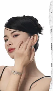 Detail of S925 sterling silver pearl bracelet with crystal charm on model wrist