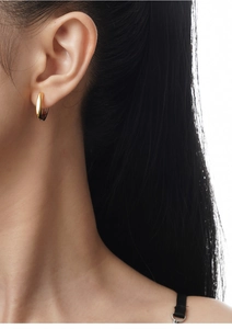 Detail view of gold S925 sterling silver hoop earring with visible material hallmark