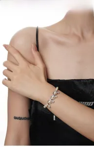Detail of S925 sterling silver baroque pearl bracelet with sparkling zircon on wrist