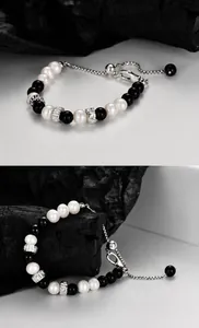 Detail of obsidian and freshwater pearl bracelet with S925 silver beads and adjustable chain