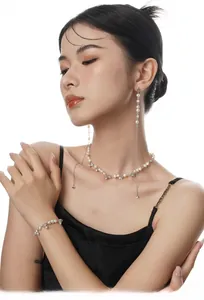 Elegant model wearing S925 silver pearl necklace, bracelet and long tassel earrings set