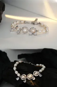 Macro detail of S925 sterling silver baroque pearl bracelet with zircon charms and lobster clasp