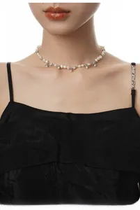 Detail of S925 sterling silver flower necklace with baroque pearls and diamonds on a model