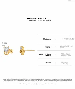 Detail of S925 sterling silver mismatched gold earrings with zircon and white agate