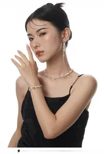 Detailed view of model wearing Baroque pearl tassel earrings and matching jewelry set