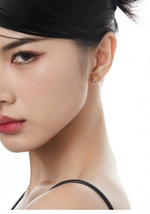 Close-up of model wearing S925 silver geometric stud earring with amber and clear stones
