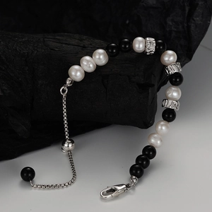 S925 silver bracelet with freshwater pearls and black obsidian on charcoal props