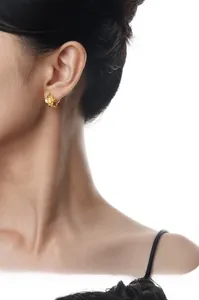 Detailed view of elegant gold clover earrings featuring agate petals and center pearl accent