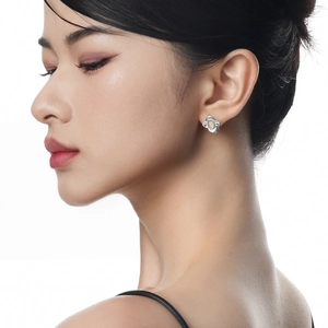 Elegant S925 sterling silver four-leaf clover flower earrings with white shell on a model