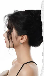 Macro detail of silver irregular C-shaped lava stud earring on a female model