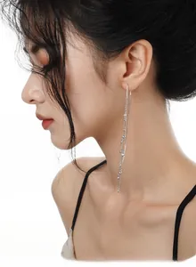 Detail of long S925 sterling silver tassel earrings with shimmering cubic zirconia