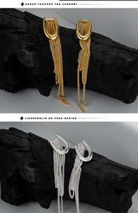 Detailed close-up of U-shaped silver tassel earrings in gold and silver finish