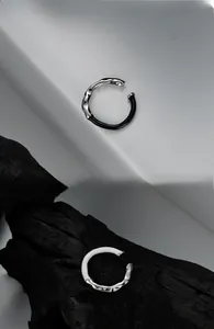 Close-up of S925 silver liquid metal ring with black and white enamel textures