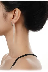 Detail of S925 sterling silver long tassel earrings with U-shaped hook on a model