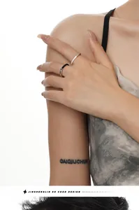 Detailed view of bicolor S925 silver rings with black and white drip glaze on model's hand