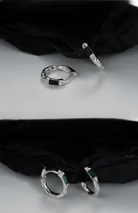Detail of S925 silver textured earrings featuring black and emerald green rectangular stones