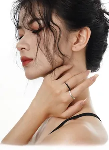 Detail of minimalist S925 silver liquid metal rings with black and white enamel glaze