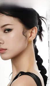 Detail shot of wavy gold sterling silver earrings worn by model with minimalist texture