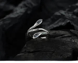 Macro view of S925 sterling silver snake ring with marquise blue stones on charcoal