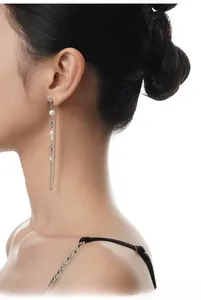 Detailed view of S925 sterling silver tassel earrings with baroque pearls on a model