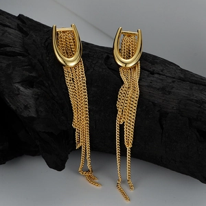 Elegant gold U-shape tassel drop earrings with long metal fringe on charred wood base
