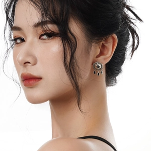 S925 sterling silver hex star earrings with black tassel drops worn by a female model