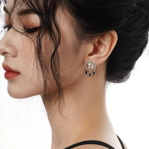 Ethnic S925 sterling silver hexagram stud earrings with black tassel pendants on model