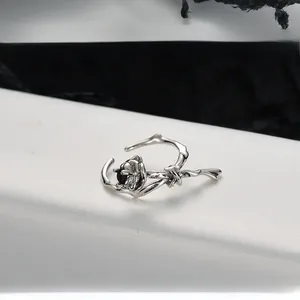 Detailed view of S925 silver thorn rose ring featuring a faceted black gemstone inlay