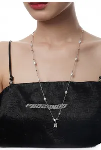 Detail of S925 silver long necklace featuring baroque pearls and a zircon pendant