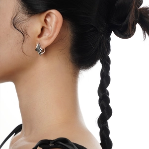 Minimalist S925 sterling silver wave hoop earrings on a model with a rippled texture