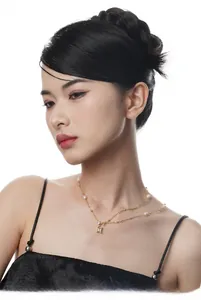 Detail of double-layer gold necklace featuring baroque pearls and rectangular zircon pendant