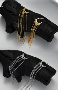 Macro detail of elegant S925 sterling silver tassel drop earrings in gold and silver