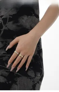 Detail of S925 sterling silver shell rings with two-tone finish and baguette zircon