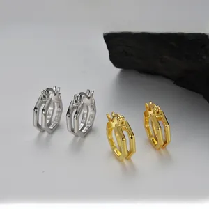 Detailed close-up of S925 sterling silver and 18K gold geometric hexagonal earrings