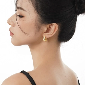 Boucles d'oreilles S925 en argent à texture dorée irrégulière et émail blanc sur mannequin