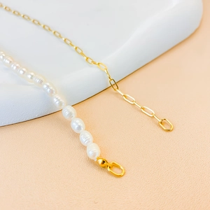 Close-up of elegant freshwater pearl necklace with golden oval link stainless steel chain